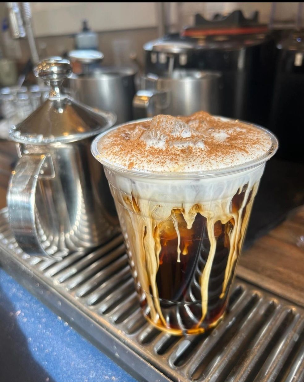 Fresh espresso pouring into a metal pitcher at Mocha Lisa